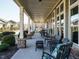 Relaxing community porch with multiple chairs and a small table at 116 Telluride Trl, Garner, NC 27529