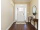 Bright entryway with hardwood floors, white door and console table at 116 Telluride Trl, Garner, NC 27529
