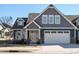 Gray two-story house with white garage door and landscaping at 116 Telluride Trl, Garner, NC 27529