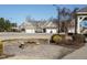 Stone fire pit area with surrounding seating and landscaping at 116 Telluride Trl, Garner, NC 27529