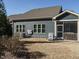 Rear view of the house, showcasing the screened porch and landscaping at 116 Telluride Trl, Garner, NC 27529