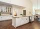 Open kitchen with large island, white cabinets, and stainless steel appliances at 116 Telluride Trl, Garner, NC 27529