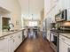 Eat-in kitchen with island, stainless steel appliances, and hardwood floors at 116 Telluride Trl, Garner, NC 27529