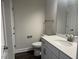 Clean bathroom with white vanity and dark wood-look flooring at 1315 Richfield Oaks Dr, Homesite 3, Fuquay Varina, NC 27526