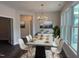 Bright dining room with concrete table, white chairs, and a chandelier at 1315 Richfield Oaks Dr, Homesite 3, Fuquay Varina, NC 27526