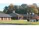 Brick building with a landscaped lawn and flagpoles at 1315 Richfield Oaks Dr, Homesite 3, Fuquay Varina, NC 27526