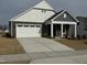 Two-story house with gray and white siding, a stone facade, and a two-car garage at 1315 Richfield Oaks Dr, Homesite 3, Fuquay Varina, NC 27526