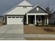 Two-story house with gray and white siding, a stone facade, and a two-car garage at 1315 Richfield Oaks Dr, Homesite 3, Fuquay Varina, NC 27526
