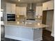 Modern kitchen with island, stainless steel appliances, and white cabinets at 1315 Richfield Oaks Dr, Homesite 3, Fuquay Varina, NC 27526