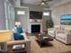Living room with comfortable seating, a fireplace, and large windows at 1315 Richfield Oaks Dr, Homesite 3, Fuquay Varina, NC 27526