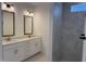 Elegant bathroom featuring double sinks, white cabinets, and a tiled walk-in shower with glass door at 134 Oban Dr, Homesite 133, Sanford, NC 27330