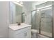 Modern bathroom showcasing a single sink, white cabinets, and a glass-enclosed tiled shower at 134 Oban Dr, Homesite 133, Sanford, NC 27330