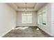 A bright dining room with large windows, wood-look tile floors and modern chandelier at 134 Oban Dr, Homesite 133, Sanford, NC 27330