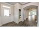 A welcoming entryway with white wainscoting, an arched doorway and wood-look tile floors at 134 Oban Dr, Homesite 133, Sanford, NC 27330