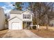 Two-story house with white siding, attached garage, and a yellow front door at 15 Gandhi Dr, Durham, NC 27703