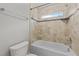 Clean bathroom with tile shower/tub combo and window at 1513 Hoke Landing Ln, Raleigh, NC 27603