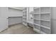 Walk-in closet with custom shelving and hanging rods at 1513 Hoke Landing Ln, Raleigh, NC 27603