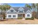 Two-story home with gray siding, gray roof, and landscaping at 1513 Hoke Landing Ln, Raleigh, NC 27603