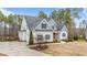 Two-story house with gray siding, stone accents, and landscaping at 1513 Hoke Landing Ln, Raleigh, NC 27603