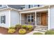 Stone front porch with wooden door and black railing at 1513 Hoke Landing Ln, Raleigh, NC 27603