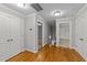 Upstairs hallway with hardwood floors and access to bedrooms at 1513 Hoke Landing Ln, Raleigh, NC 27603