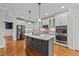 Modern kitchen with stainless steel appliances and granite countertops at 1513 Hoke Landing Ln, Raleigh, NC 27603