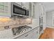Stainless steel gas cooktop and granite countertops in kitchen at 1513 Hoke Landing Ln, Raleigh, NC 27603