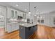 Open kitchen with island, granite counters & stainless steel appliances at 1513 Hoke Landing Ln, Raleigh, NC 27603