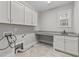 Bright laundry room featuring ample cabinetry and countertop space at 1513 Hoke Landing Ln, Raleigh, NC 27603