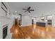 Open living room features hardwood floors, fireplace, and kitchen with island at 1513 Hoke Landing Ln, Raleigh, NC 27603