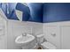 Small bathroom with white pedestal sink and toilet at 1513 Hoke Landing Ln, Raleigh, NC 27603