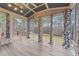 Sunroom with wood-look flooring and access to deck at 1513 Hoke Landing Ln, Raleigh, NC 27603