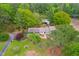 Captivating aerial view of a well-maintained home with a spacious lawn, bordered by mature trees and vibrant foliage at 1741 W Blackman Rd, Dunn, NC 28334