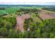 Vast aerial shot of a property bordering cultivated fields and verdant trees, highlighting the privacy and rural setting at 1741 W Blackman Rd, Dunn, NC 28334
