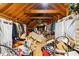 Spacious attic storage with wooden beams can be used for many purposes, but is currently cluttered at 1741 W Blackman Rd, Dunn, NC 28334