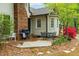 Comfortable back patio with seating, grill, and colorful flowering bushes at 1741 W Blackman Rd, Dunn, NC 28334