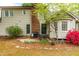 Back patio with seating, grill, and colorful flowering bushes by the house at 1741 W Blackman Rd, Dunn, NC 28334