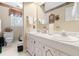 Bright bathroom featuring a dual sink vanity with white cabinets and a large mirror, creating a functional space at 1741 W Blackman Rd, Dunn, NC 28334