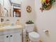 Well-lit half-bathroom with classic fixtures, white vanity, and charming decorative elements at 1741 W Blackman Rd, Dunn, NC 28334