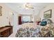 Comfortable bedroom with floral bedding, wooden accents, and natural light from the window at 1741 W Blackman Rd, Dunn, NC 28334