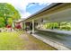 Covered carport attached to a charming home, with an outdoor seating area and manicured landscaping at 1741 W Blackman Rd, Dunn, NC 28334