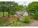 View of the home surrounded by mature trees and green lawns with a front porch for relaxing at 1741 W Blackman Rd, Dunn, NC 28334