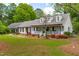Charming one-story home with a welcoming front porch and well-maintained landscaping at 1741 W Blackman Rd, Dunn, NC 28334