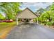 Exterior view of house showing a large carport, landscaping, and an inviting front entrance at 1741 W Blackman Rd, Dunn, NC 28334