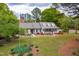 Charming home featuring dormer windows, a covered front porch, and a well-manicured front yard at 1741 W Blackman Rd, Dunn, NC 28334
