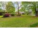 Charming home boasts a lush front yard with vibrant azaleas and a convenient covered carport at 1741 W Blackman Rd, Dunn, NC 28334