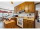 Charming kitchen features wood cabinets and breakfast nook with bright natural light at 1741 W Blackman Rd, Dunn, NC 28334