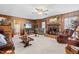 Comfortable living room with wood paneling, ceiling fan, and brick fireplace at 1741 W Blackman Rd, Dunn, NC 28334