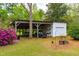 Outbuilding featuring an open air storage area and a storage garage at 1741 W Blackman Rd, Dunn, NC 28334
