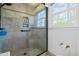 Modern tiled shower with glass enclosure and convenient built-in shelving for toiletries at 1741 W Blackman Rd, Dunn, NC 28334